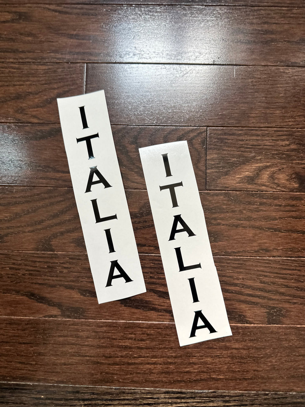 Two black ITALIA vertical lettering strips