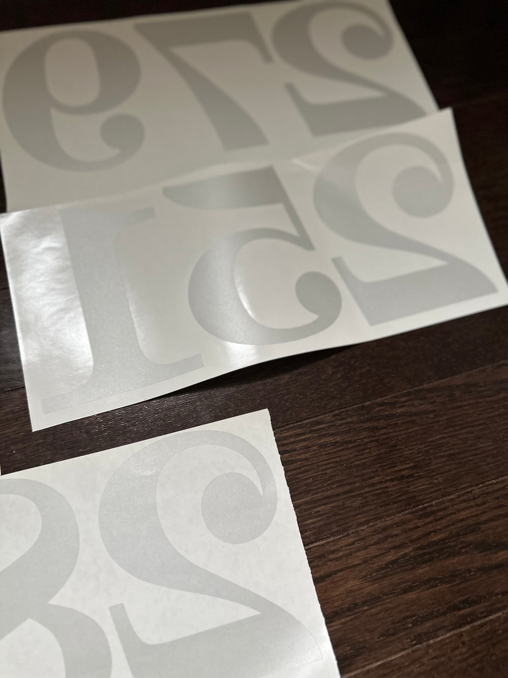Frosted number decals on curled backing sheets
