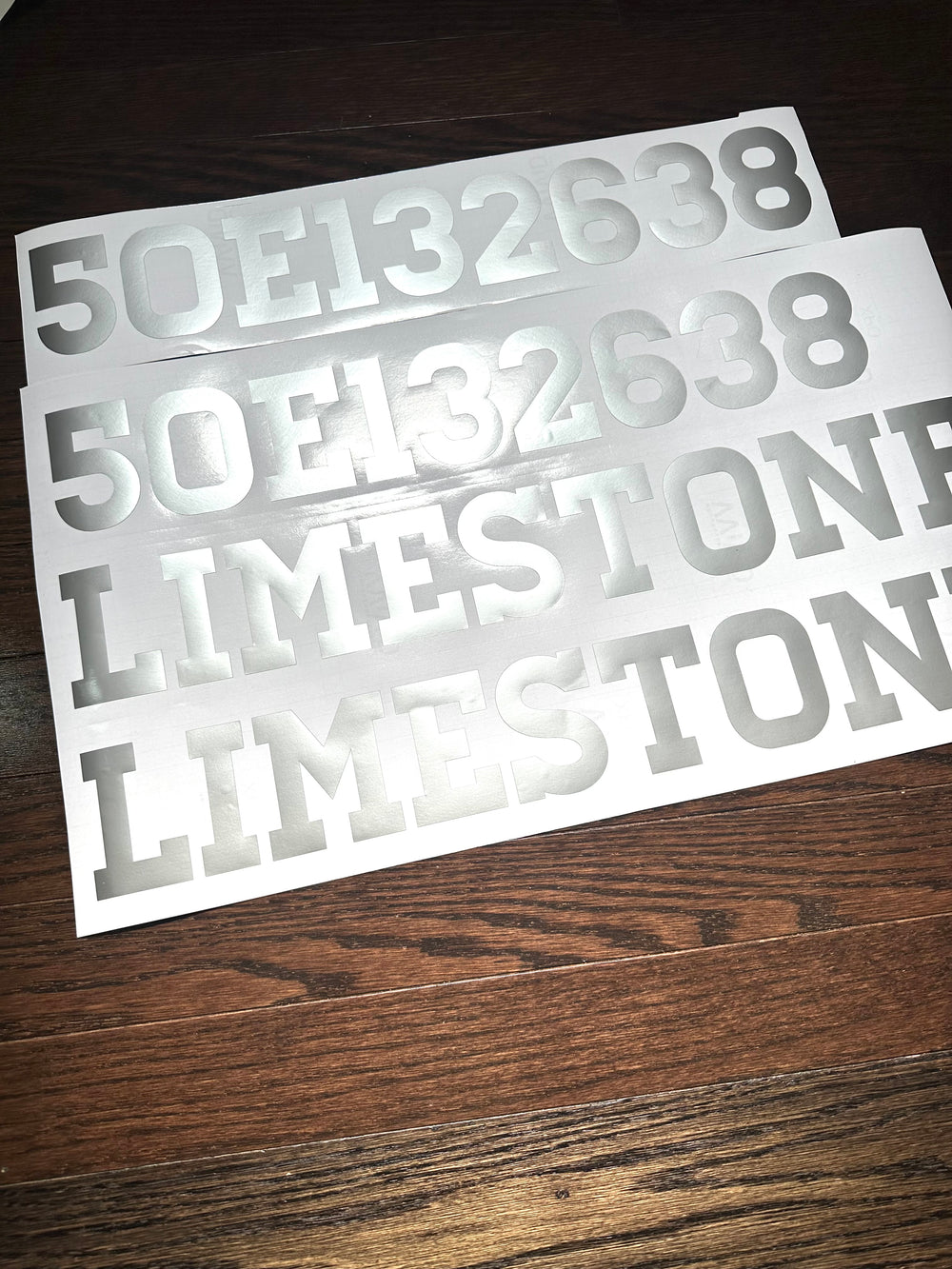 White boat registration numbers and Limestone decals on backing