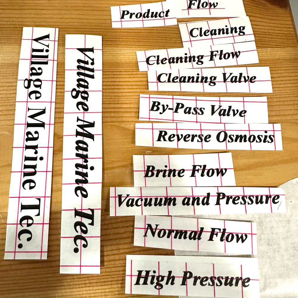 Black equipment labels including flow and pressure wording on backing sheets