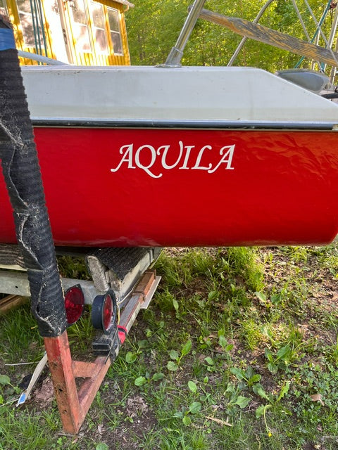 White Aquila boat name on a red hull