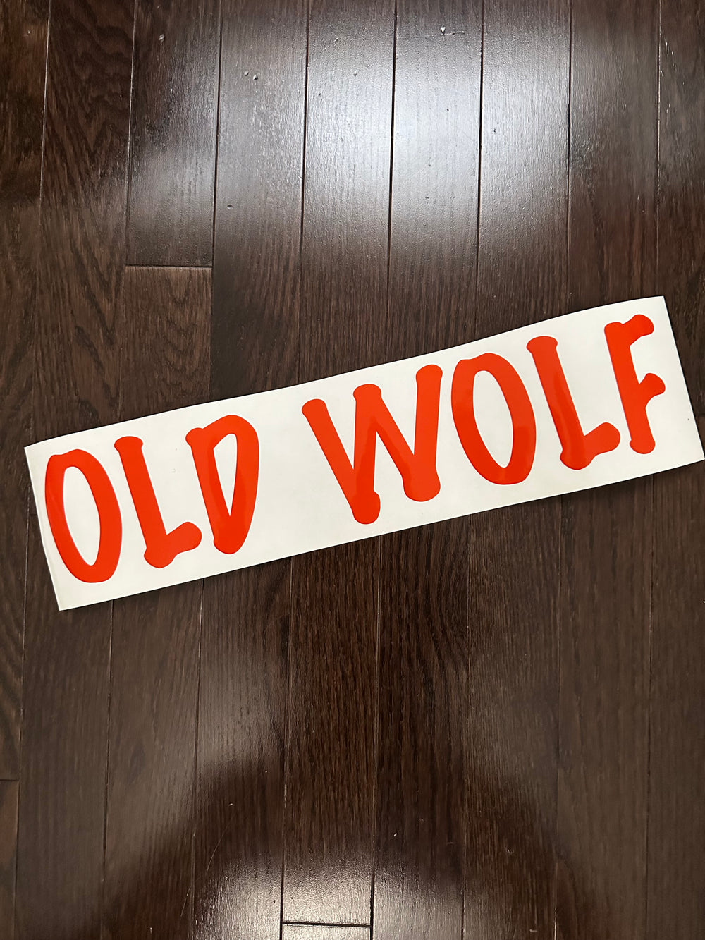 Red Old Wolf boat-name decal on backing