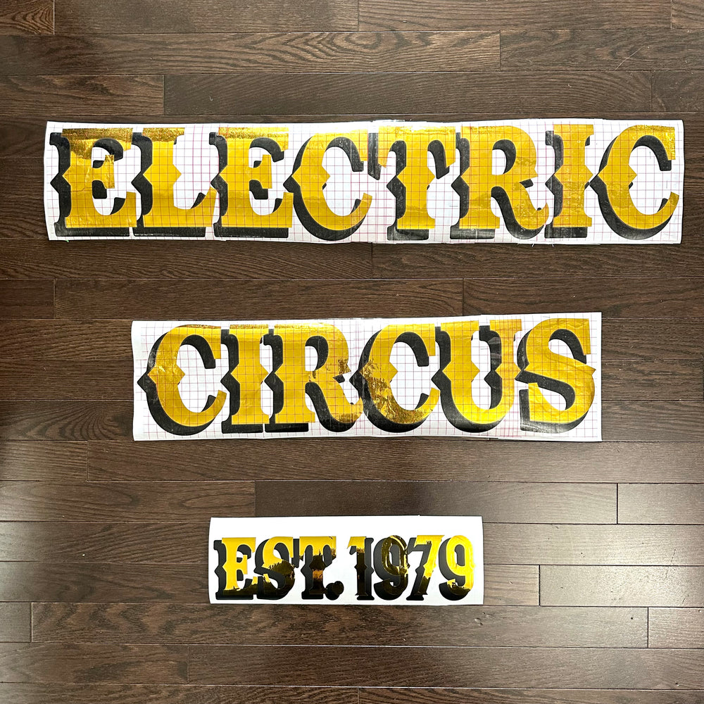 Gold and black Electric Circus and Est. 1979 lettering