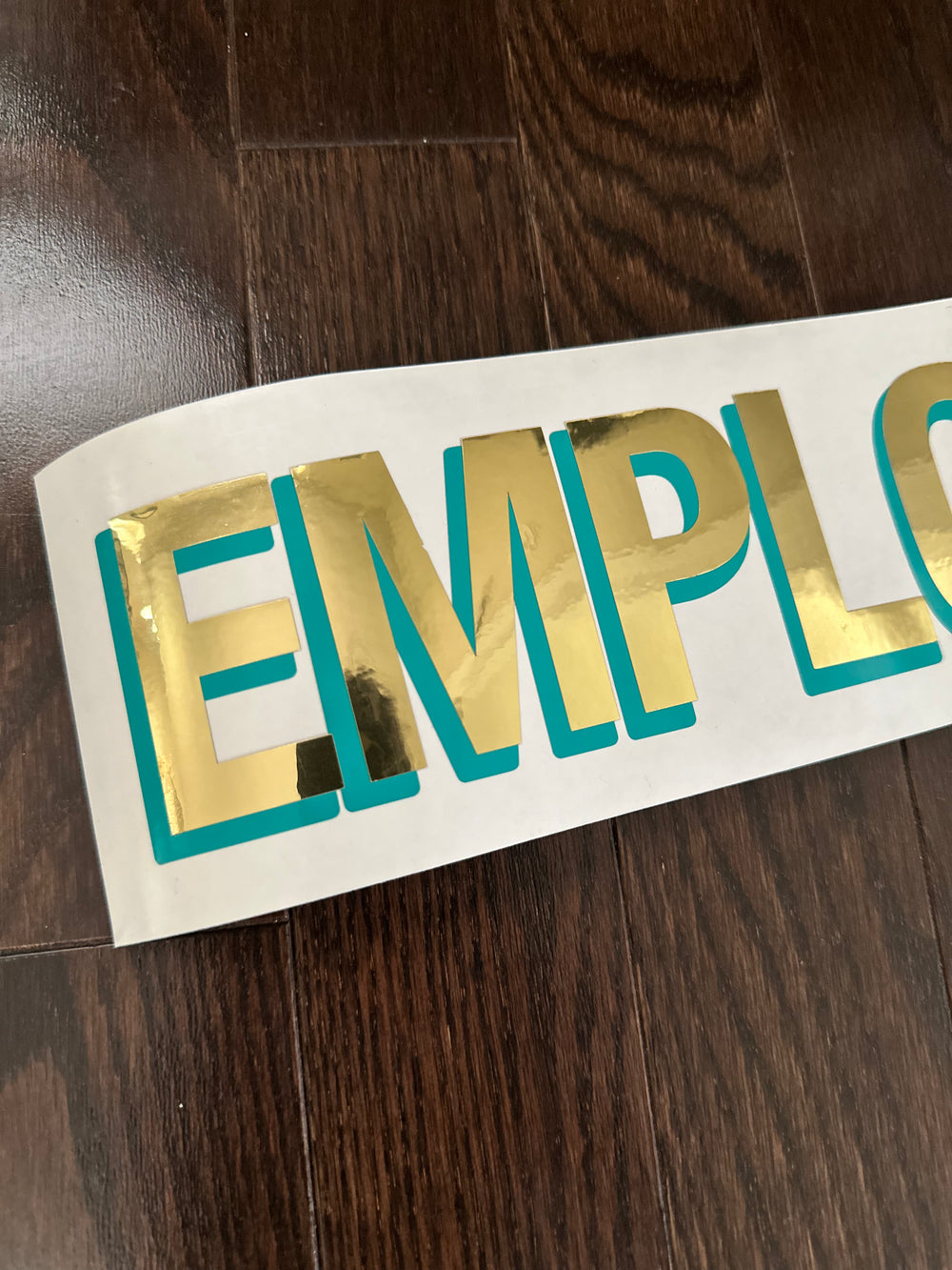 Close-up of layered Employees decal