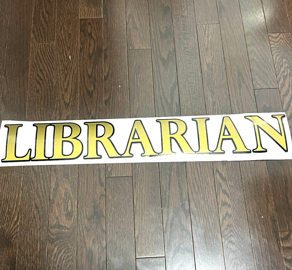 Gold and black Librarian lettering on backing