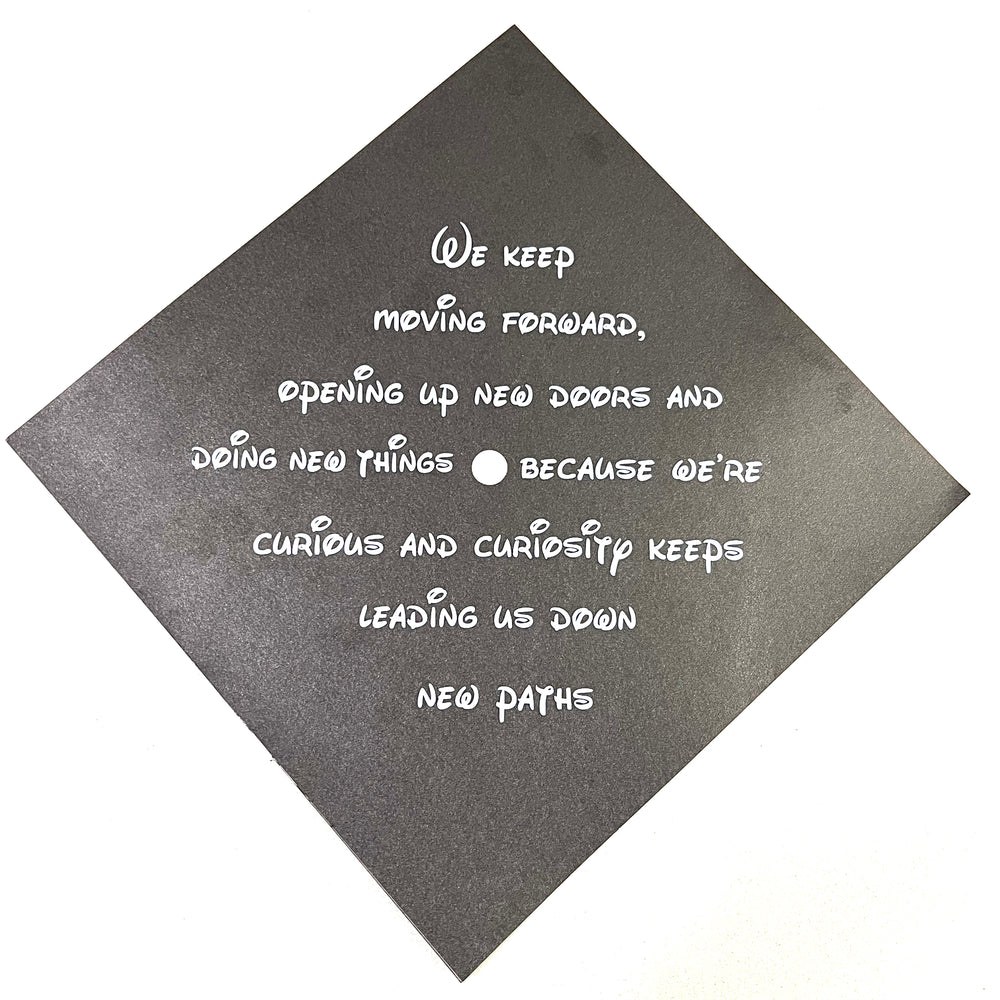 White motivational quote lettering on a black graduation cap example