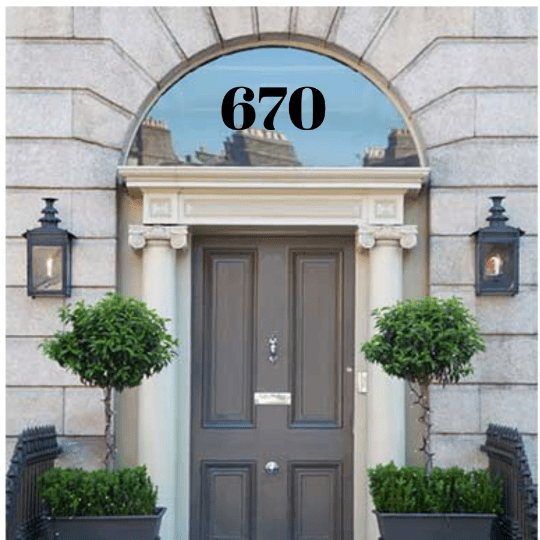 Black 670 numbers on an arched fanlight above double doors