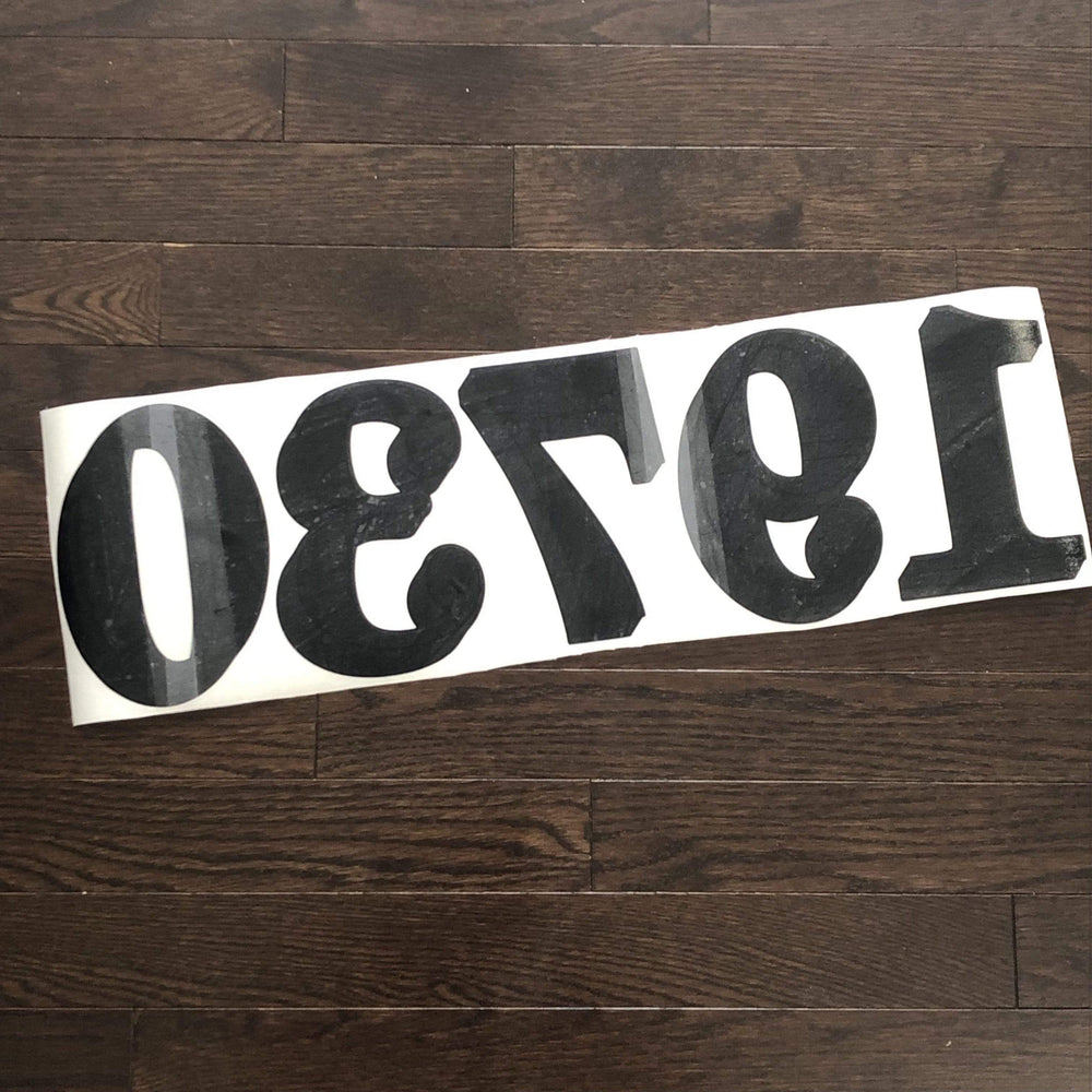 Reverse-oriented number decal laid on backing paper