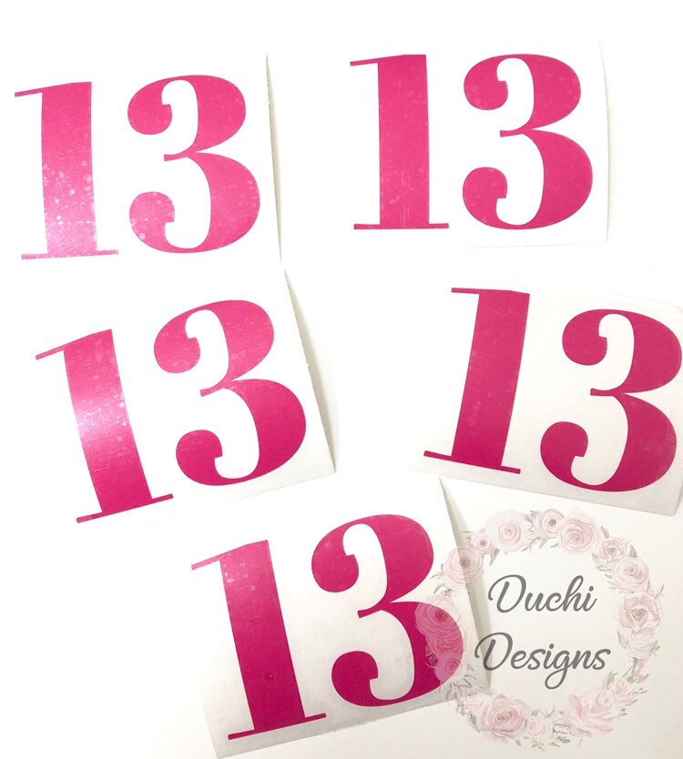 Several pink 13 number decals on backing