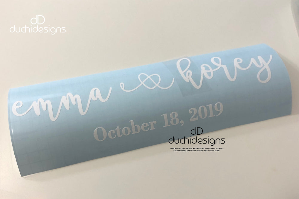 White Emma and Rory names and date on blue backing