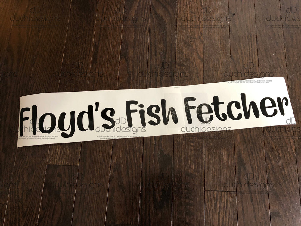 Black Floyd’s Fish Fetcher lettering on backing
