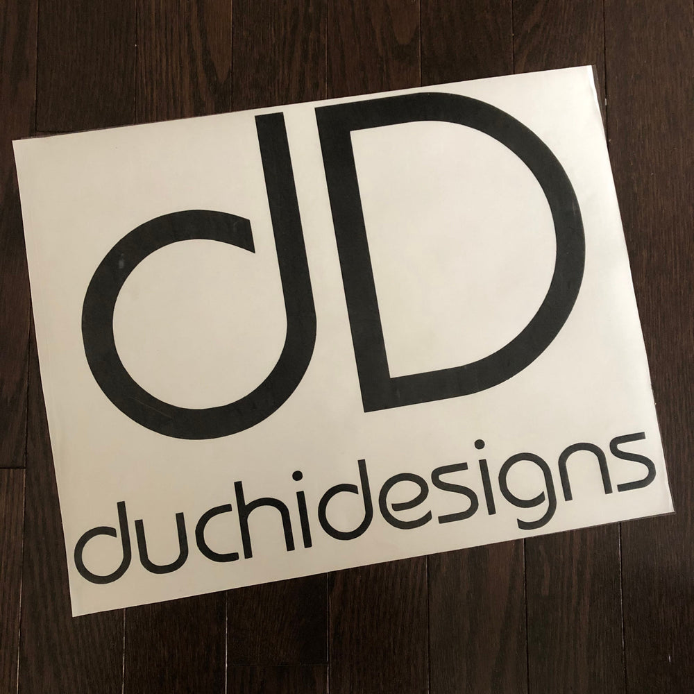 Black Duchi Designs logo decal on backing