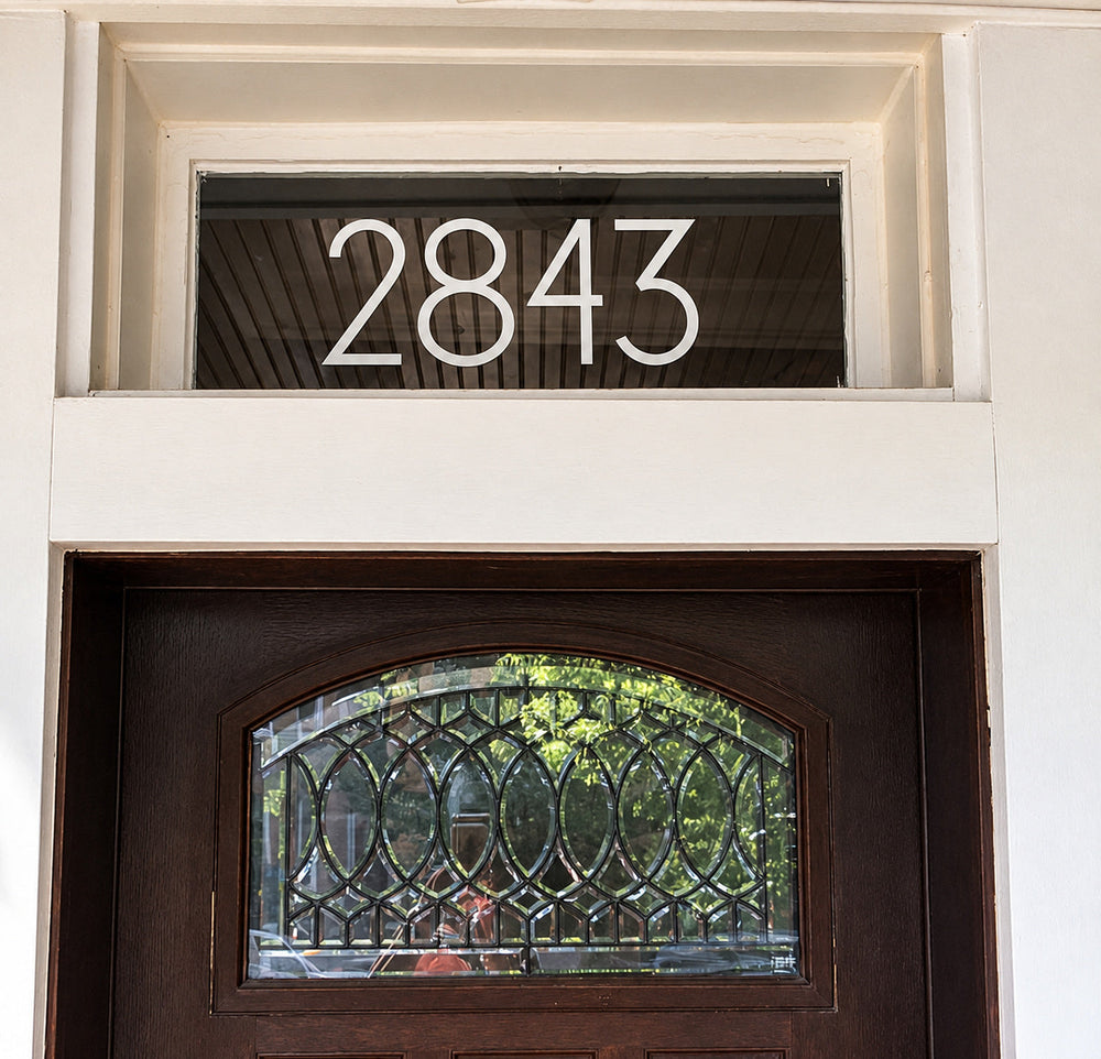 White 2843 numbers installed above an entrance door