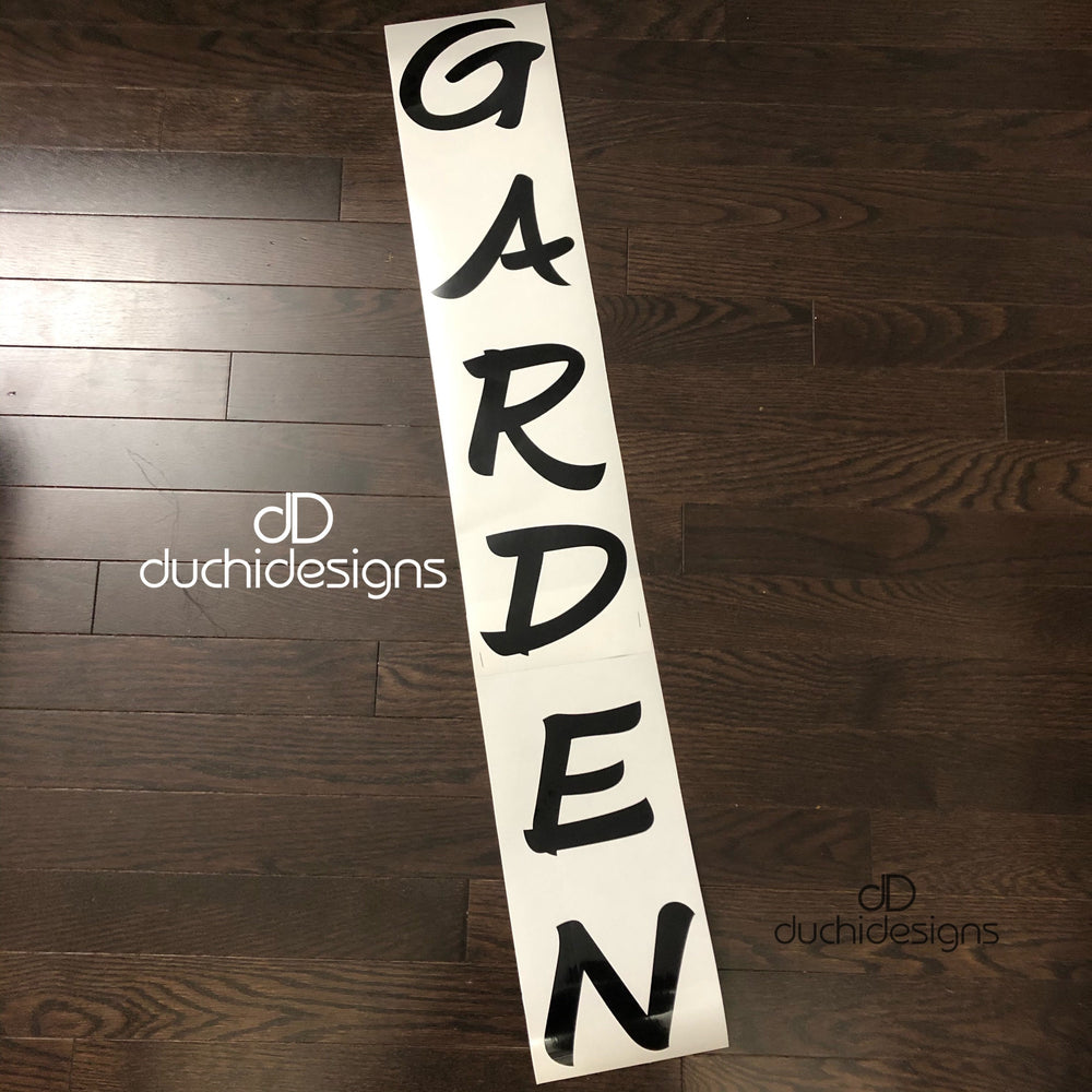 Black GARDEN lettering stacked vertically on backing