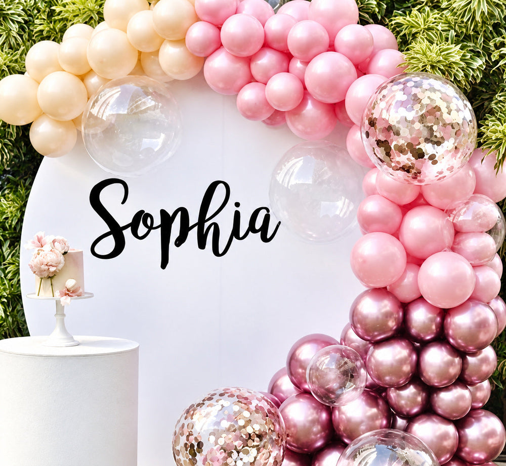 Sophia script name lettering on a round baby shower display