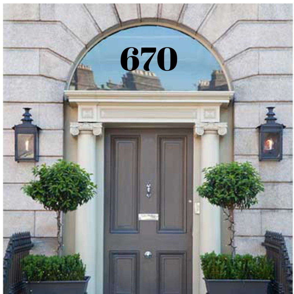 Black 670 house numbers on arched fanlight glass