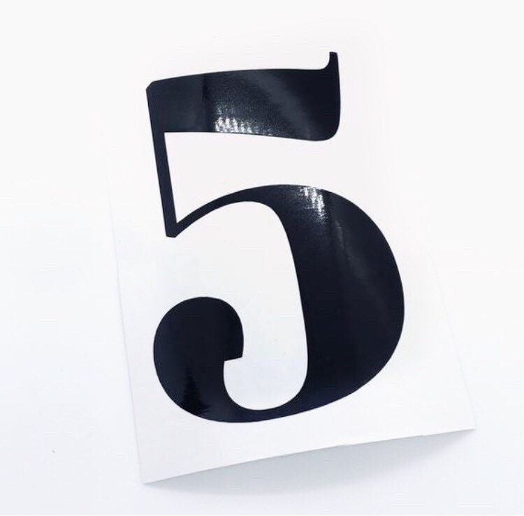 Single black digit 5 on backing