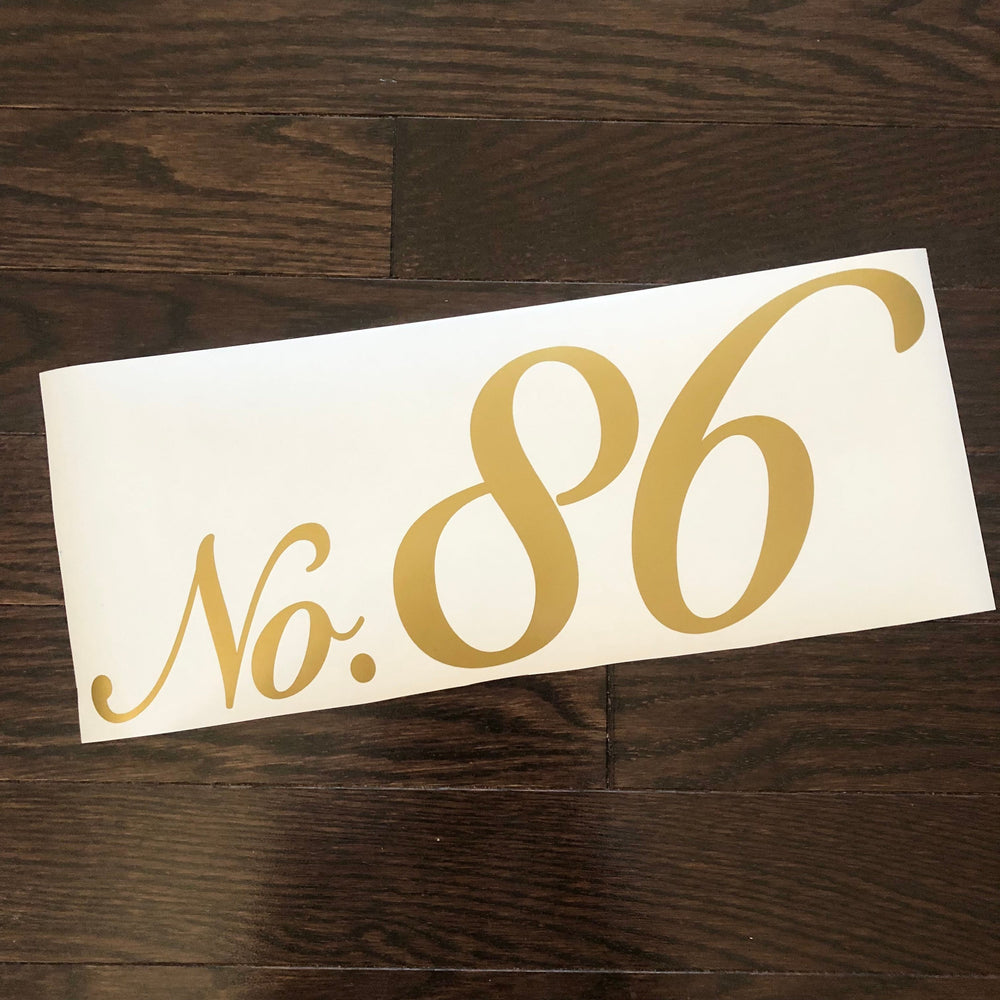 Gold-coloured No. 86 script number decal on backing