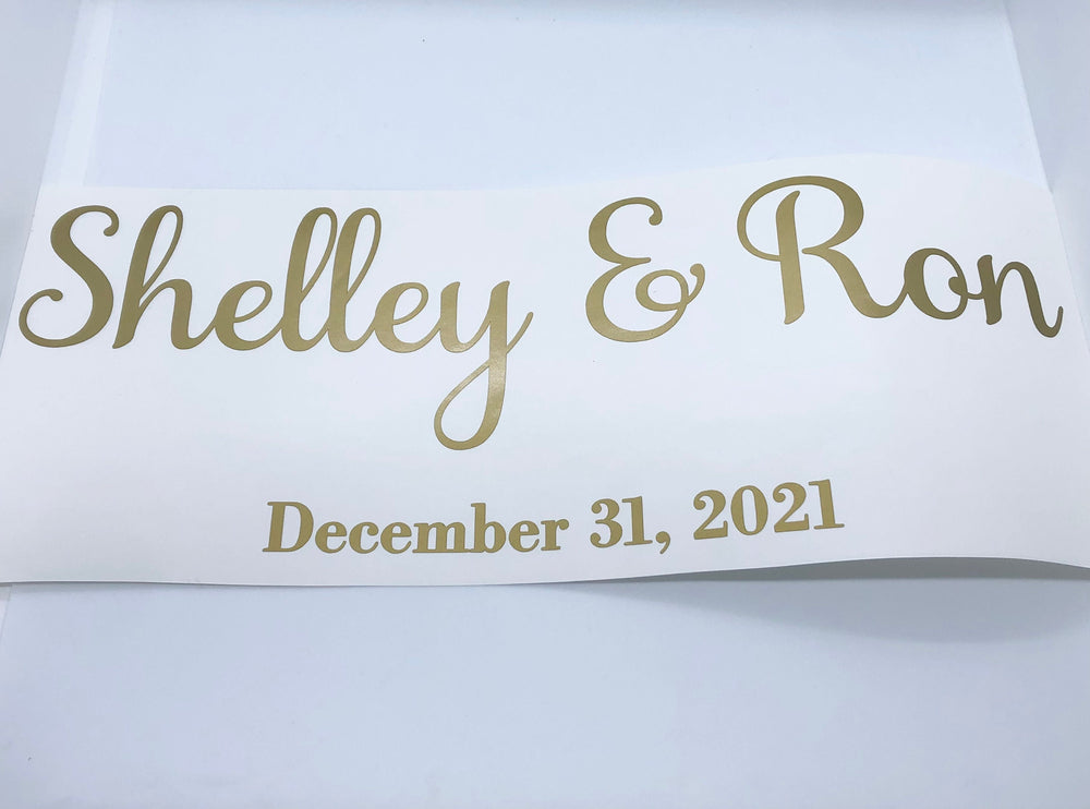 Gold-coloured Shelley & Ron wedding lettering on backing