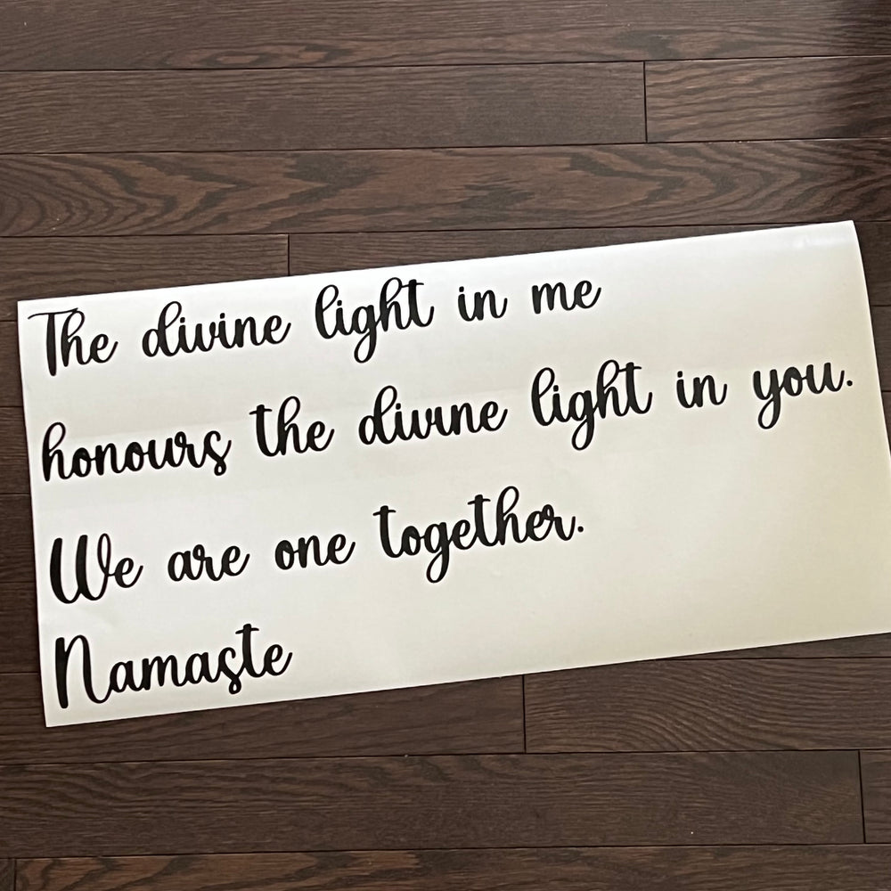 Black multi-line Namaste quote on white backing paper