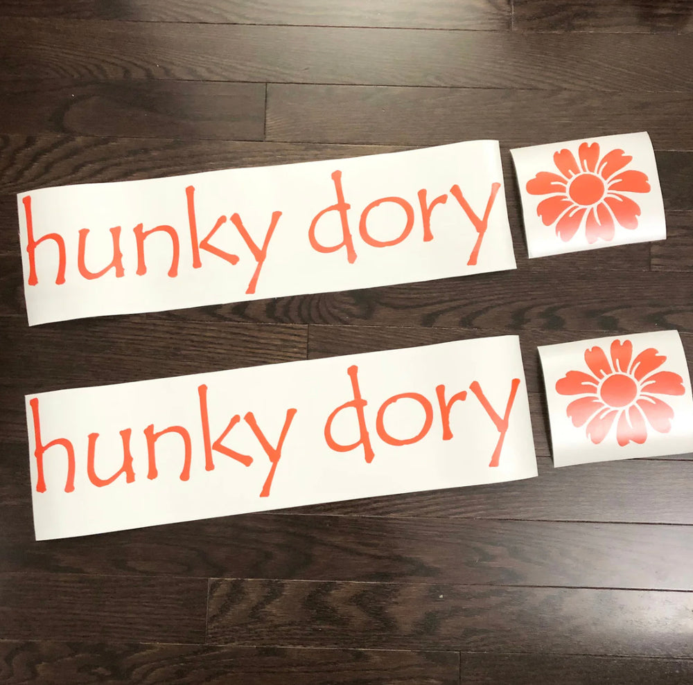 Orange hunky dory lettering and flower decals on backing