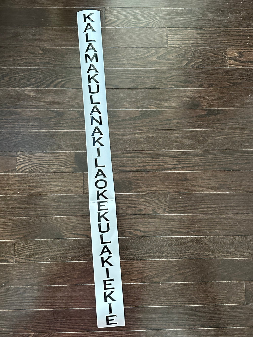 Long black vertical name decal on backing