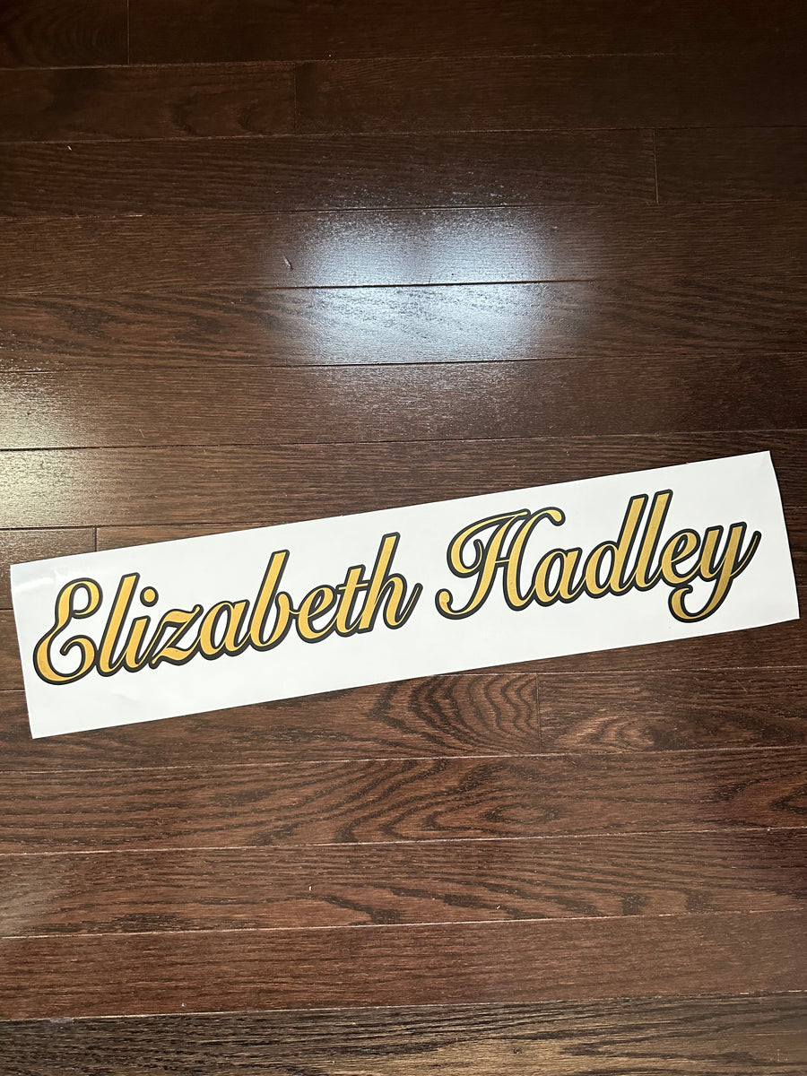 Gold and black Elizabeth Hadley script lettering