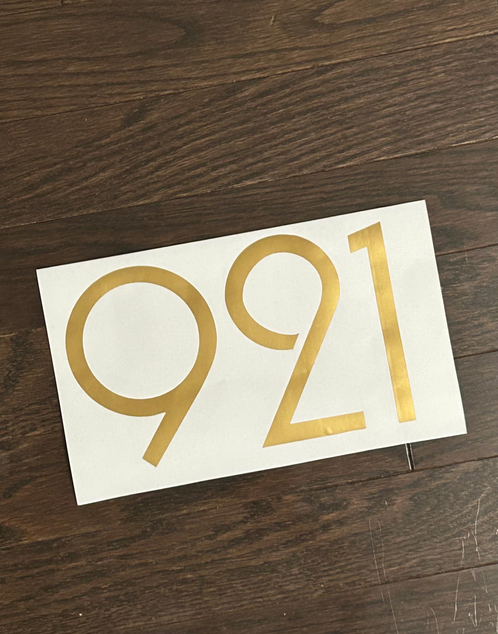 Gold-coloured 921 digits on backing