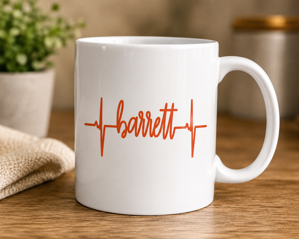 Example of orange Barrett heartbeat lettering on a white mug