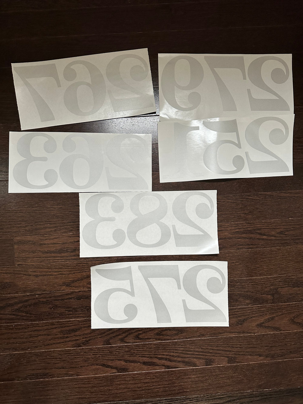 Frosted number decals arranged on a wooden surface
