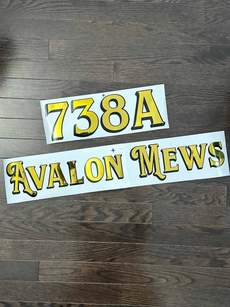 Gold and black 738A Avalon Mews lettering on backing