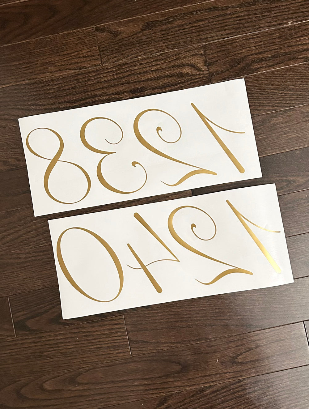 Reverse-oriented gold-coloured number decals on backing sheets