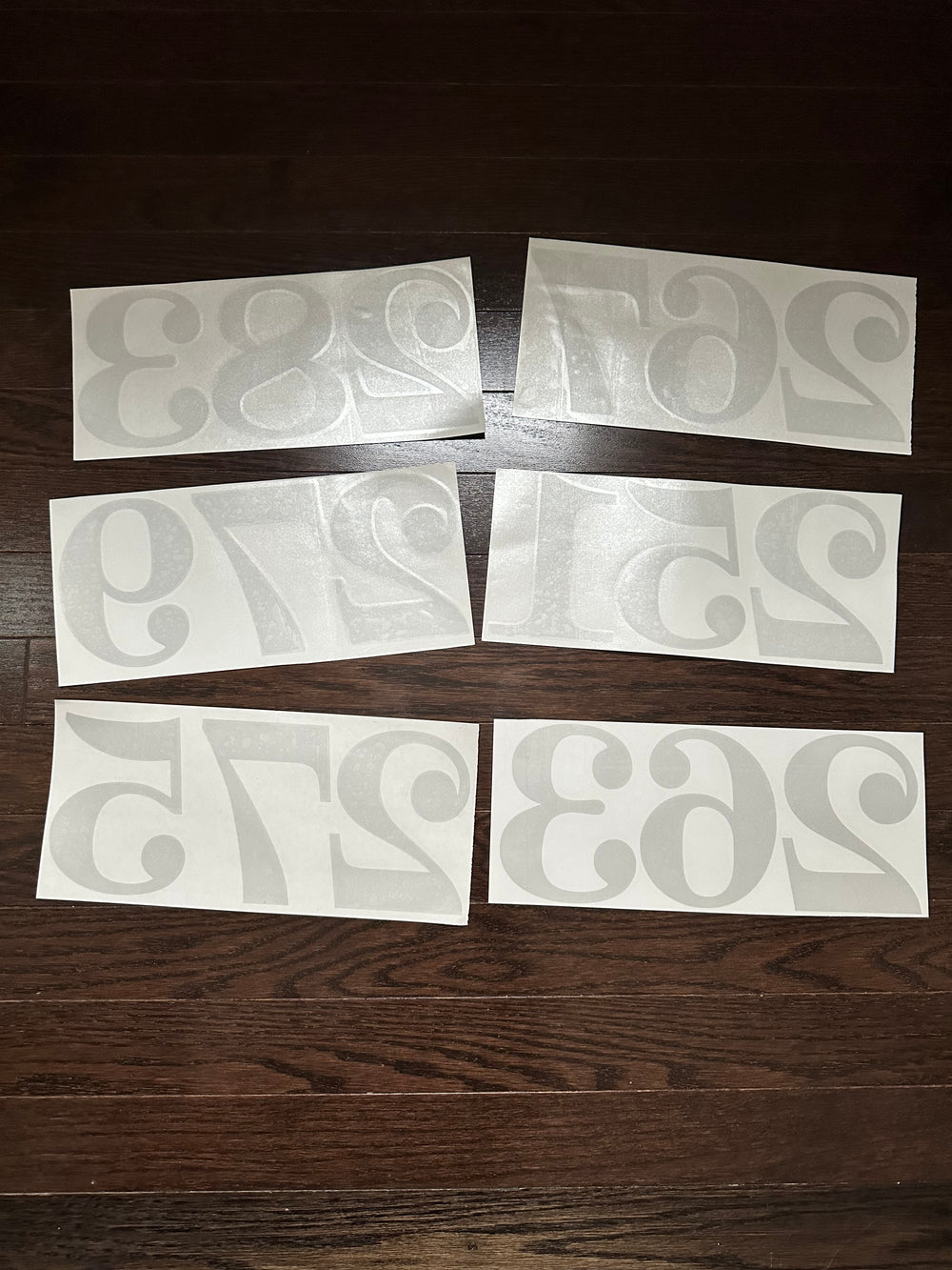 Multiple frosted number decals on backing paper