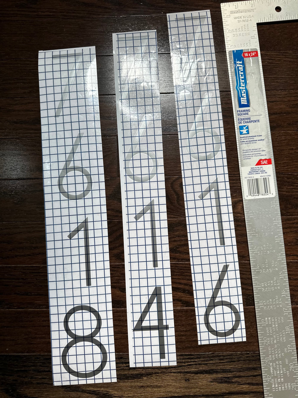 Thin black vertical digit decals on gridded transfer tape