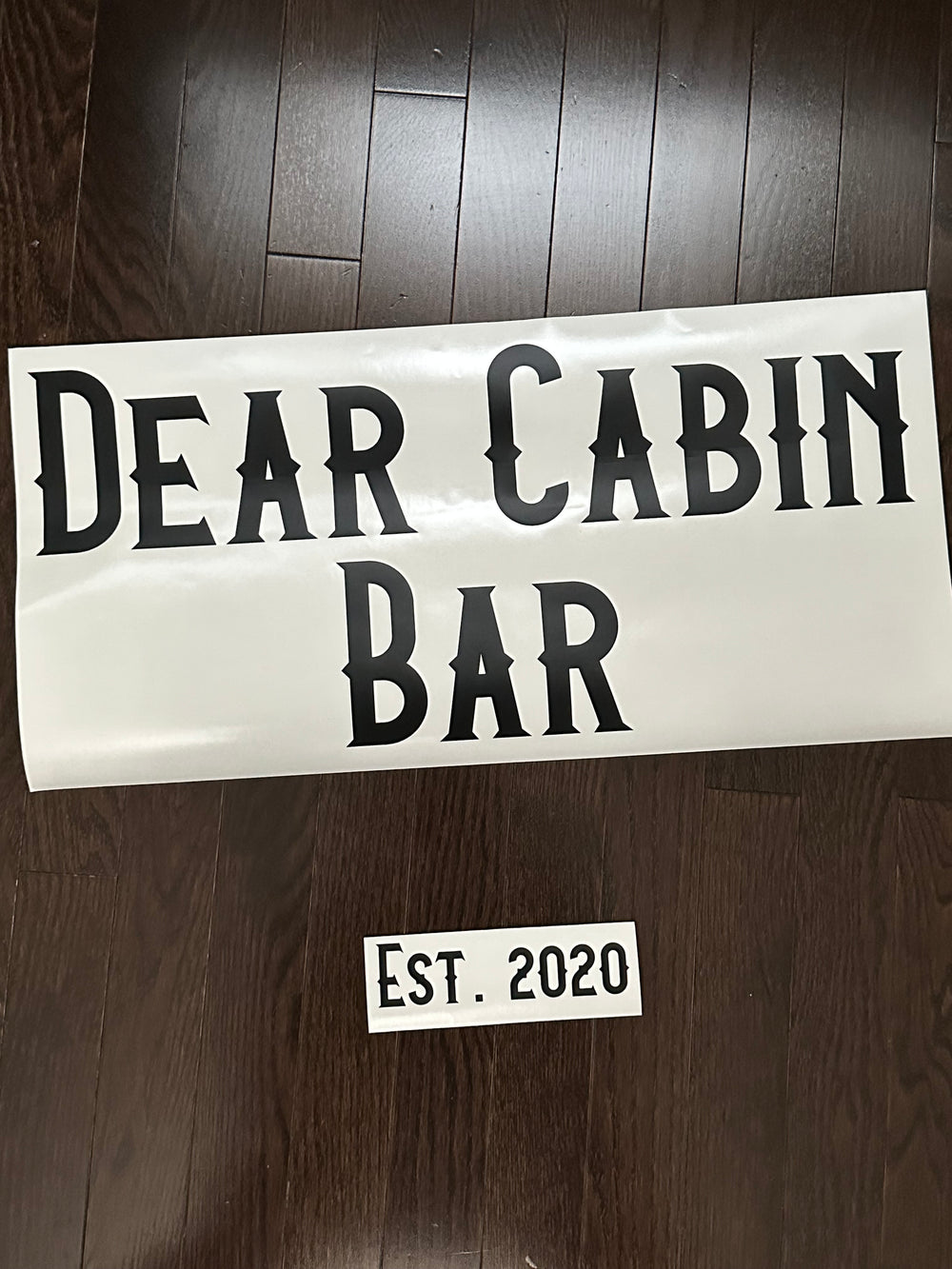 Black Dear Cabin Bar lettering and establishment date