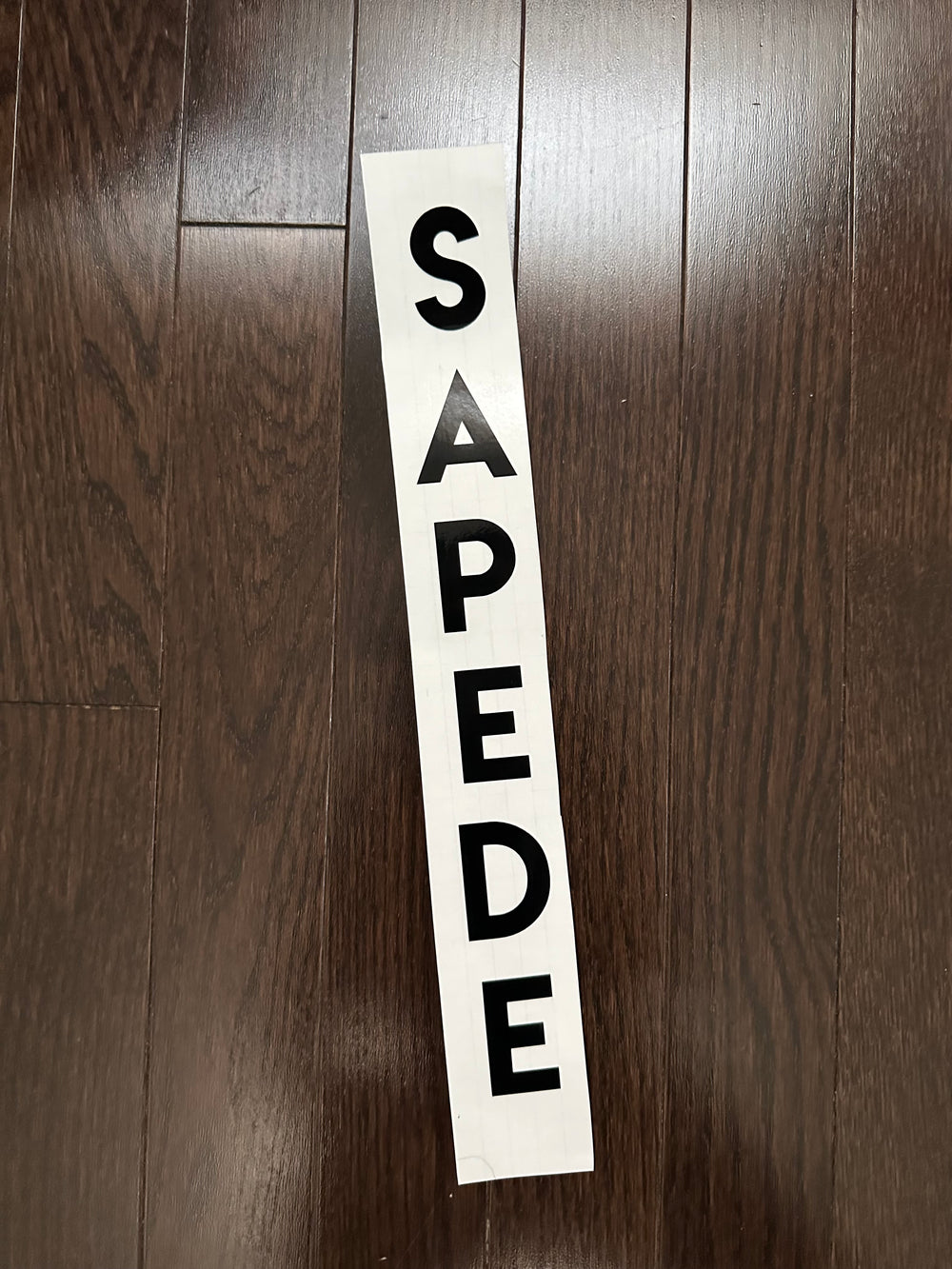Black SAPPE stacked lettering on backing