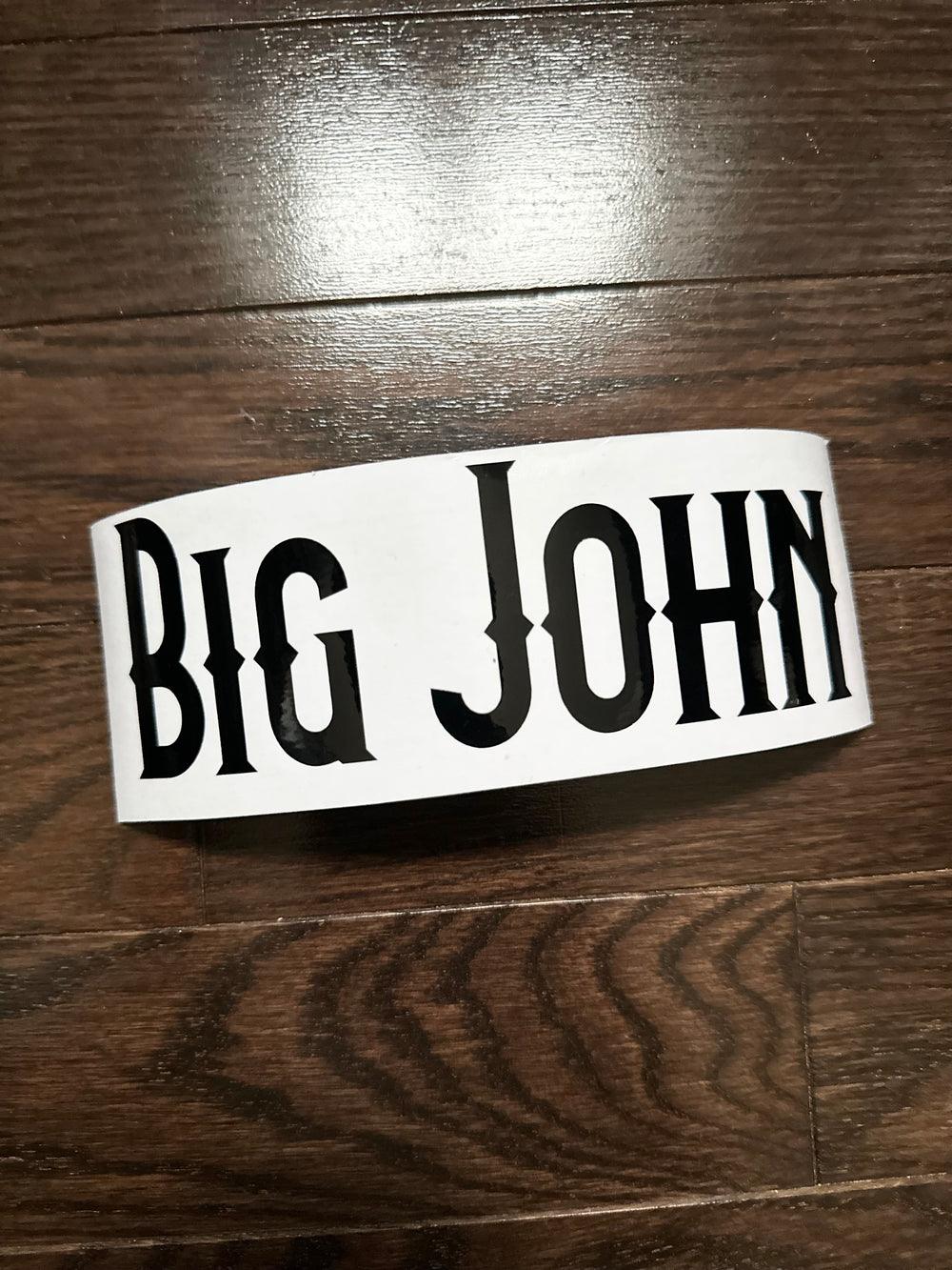 Black Big John lettering on backing paper