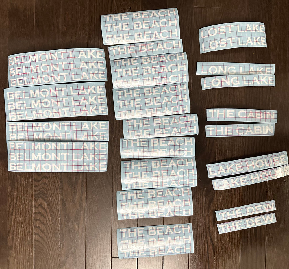 Multiple small text decals arranged on gridded transfer sheets
