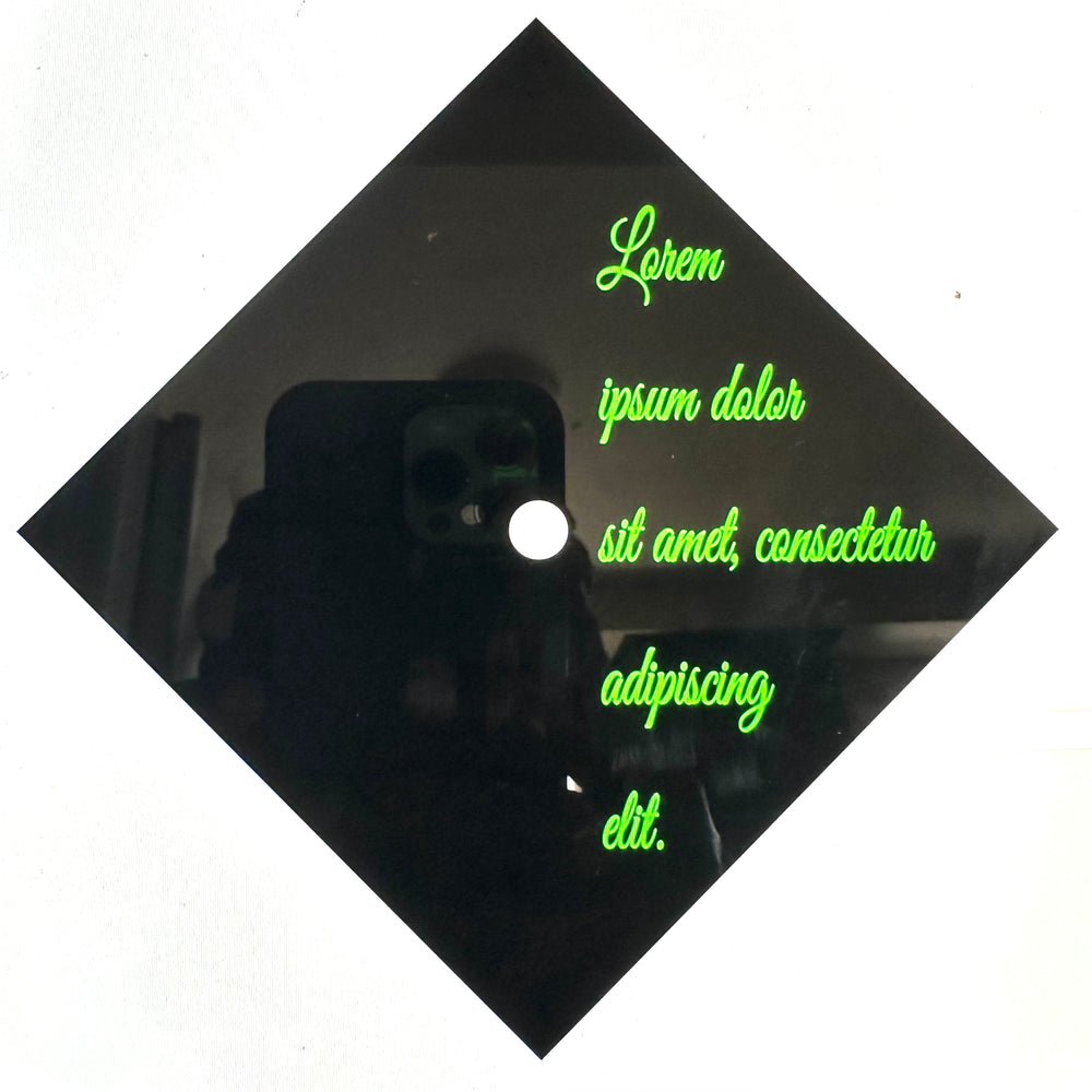 Green placeholder lettering on a black graduation cap example