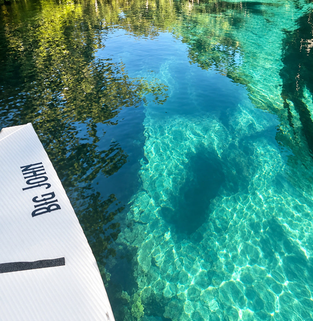 Big John lettering visible on a boat beside clear blue water
