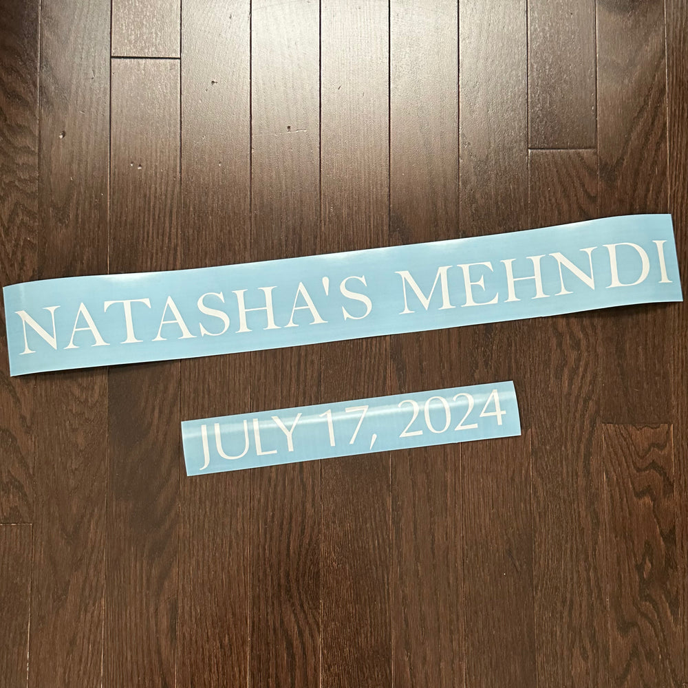 White Natasha’s Mehndi and July 17 2024 lettering on blue backing