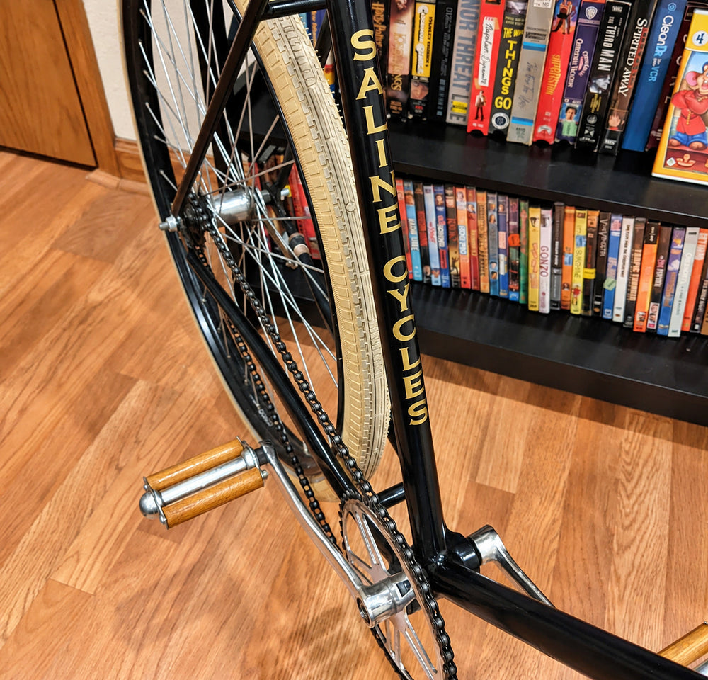 Yellow stacked lettering on a bicycle frame