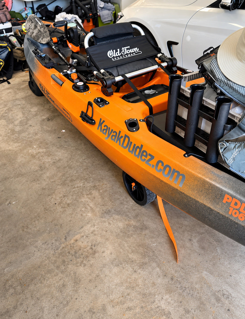 KayakDudez.com lettering along an orange fishing kayak
