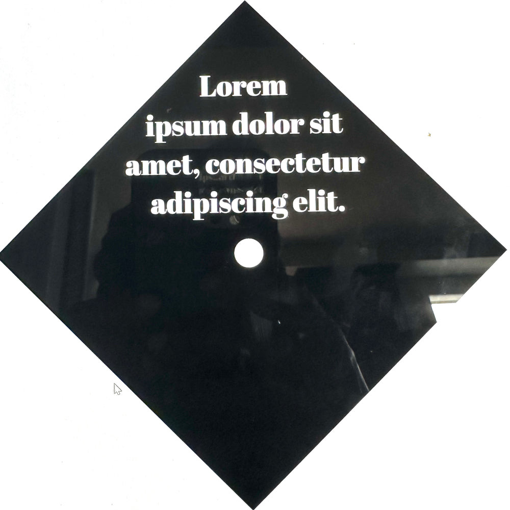 White placeholder lettering on a black graduation cap example