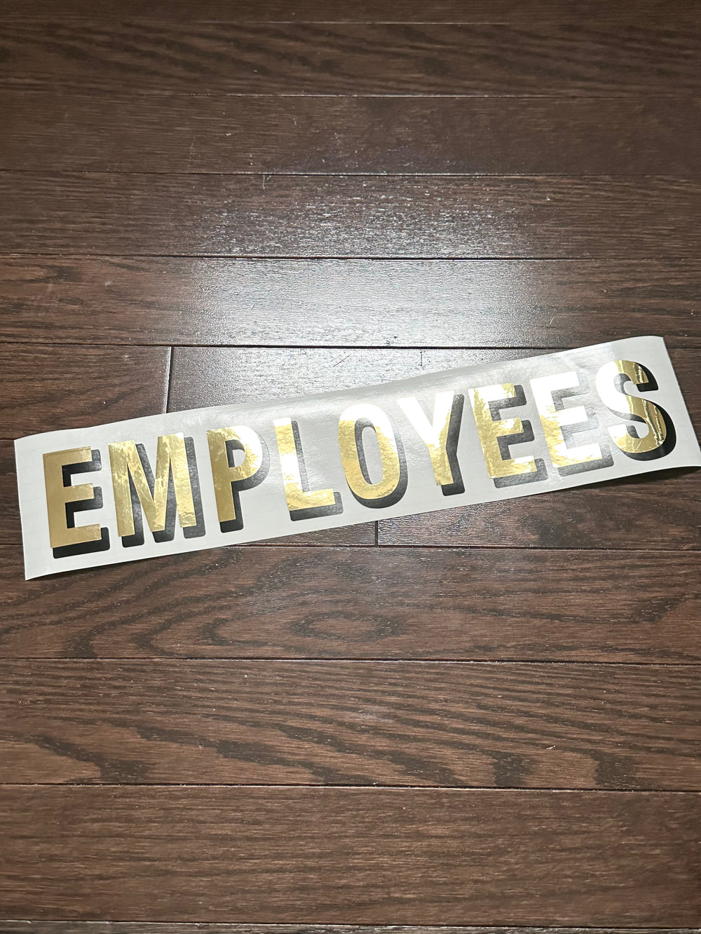 Gold-coloured Employees lettering on backing