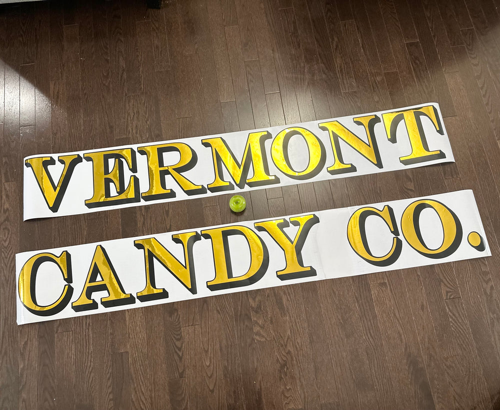 Gold and black Vermont Candy Co. lettering on backing