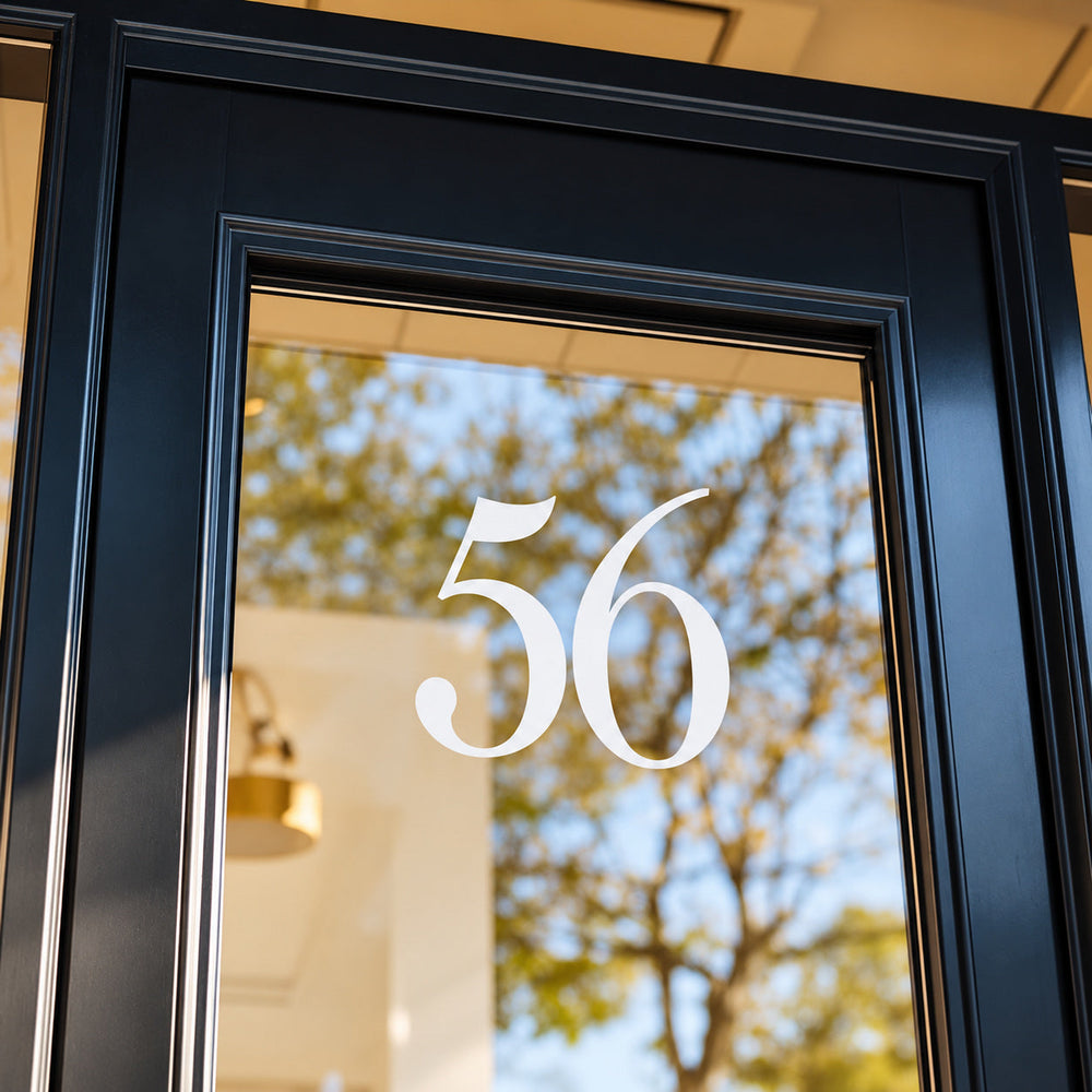 White 56 numbers on glass within a dark door frame