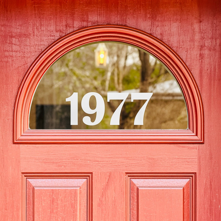 Example red door with white 1977 numbers in arched glass