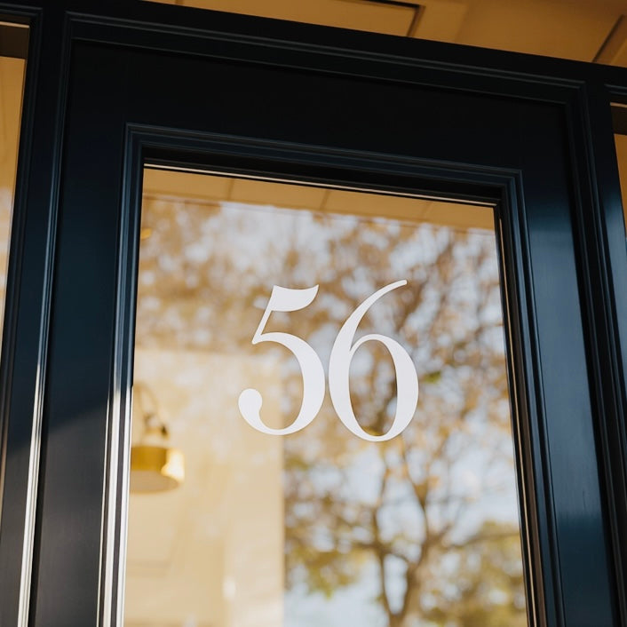 White 56 house numbers on a glass door