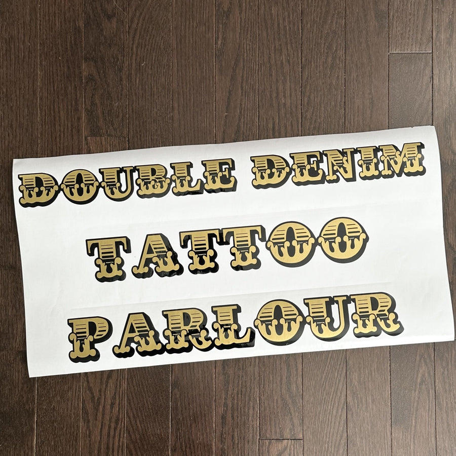 Gold and black Double Denim Tattoo Parlour decal